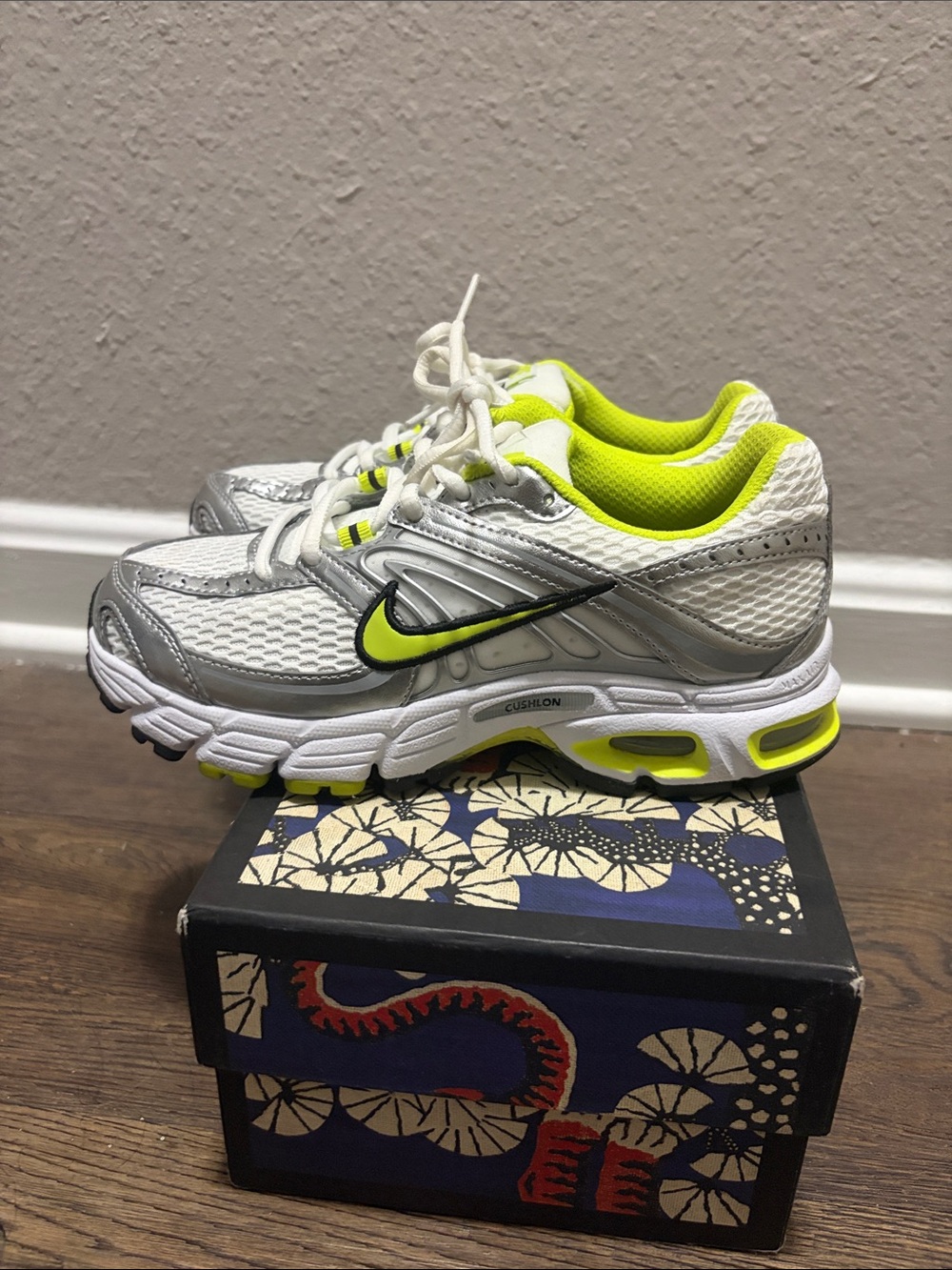Nike Air Max Moto 2K in the White/Cyber/Metallic Silver colorway, featuring vibr